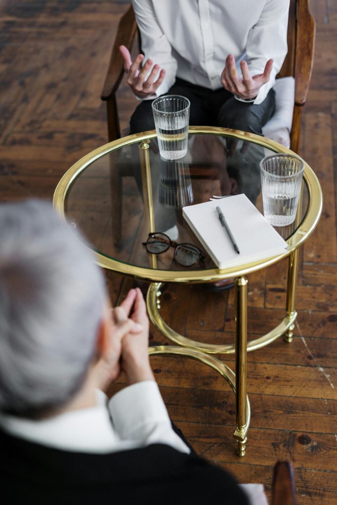 pexels-photo-4098369-4098369 Woman in Black Long Sleeve Shirt Sitting on Brown Wooden Chair