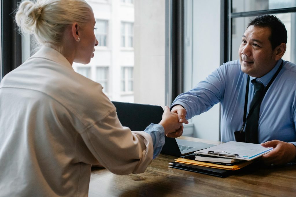 pexels-photo-5668859-5668859 Ethnic businessman shaking hand of applicant in office